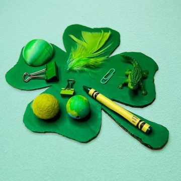 Child's mixed media collage on a green cardboard shamrock.