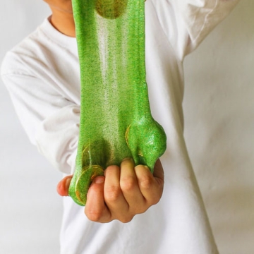 Stretched green slime with gold coins.