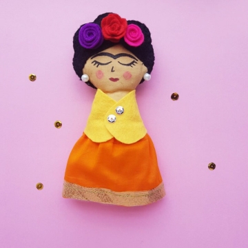 Homemade Frida Kahlo doll with floral headband.