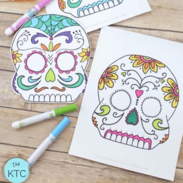 Colored print-outs of sugar skull masks on white paper.